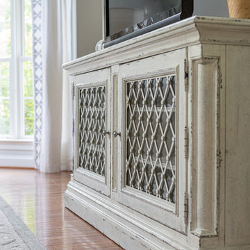 Neutral Two Story Family Room with Tufted Wing Chairs