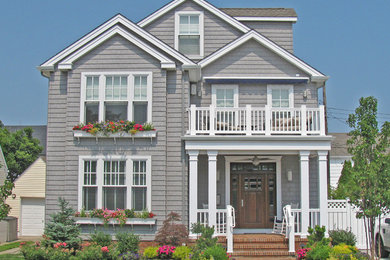 Example of a large classic gray two-story wood exterior home design in Philadelphia