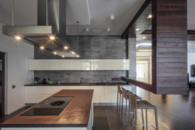 This is an example of a large contemporary l-shaped eat-in kitchen in Moscow with an undermount sink, flat-panel cabinets, quartz benchtops, porcelain floors, with island, brown floor, brown benchtop and white cabinets.