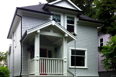 Inspiration for a mid-sized craftsman gray two-story wood exterior home remodel in Vancouver with a hip roof