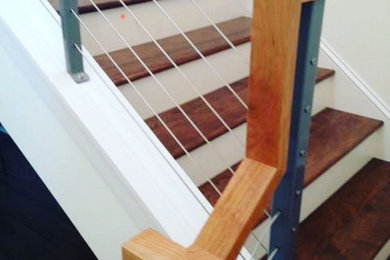 Mid-sized urban wooden u-shaped staircase photo in Minneapolis with painted risers