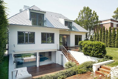 Example of a mid-sized minimalist backyard deck design in Other with no cover