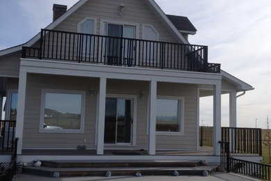 Large farmhouse side porch photo in Calgary with decking