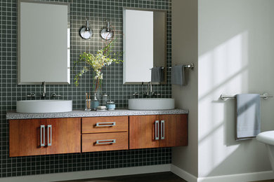 Photo of a mid-sized contemporary master bathroom in Other with flat-panel cabinets, medium wood cabinets, a freestanding tub, green tile, grey walls, a vessel sink and brown floor.