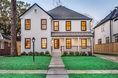 Example of a minimalist white two-story brick exterior home design in Houston