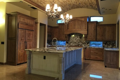 Open concept kitchen - large transitional u-shaped porcelain tile and beige floor open concept kitchen idea in Phoenix with an undermount sink, raised-panel cabinets, medium tone wood cabinets, quartz countertops, multicolored backsplash, stone slab backsplash, stainless steel appliances and an island