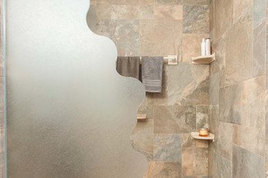Eclectic master bathroom in Indianapolis with an open shower, brown tile, ceramic tile and pebble tile floors.