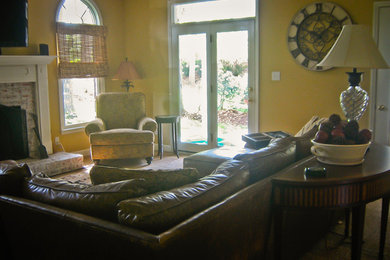 Example of a mid-sized classic enclosed carpeted living room design in Other with yellow walls and a standard fireplace