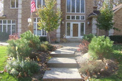 Example of a large brown two-story stone exterior home design in Other