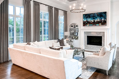 Example of a large minimalist open concept medium tone wood floor, brown floor and coffered ceiling living room design in Dallas with white walls, a stone fireplace and a wall-mounted tv