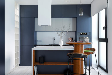 Réalisation d'une cuisine ouverte parallèle design de taille moyenne avec des portes de placard bleues, un plan de travail en quartz modifié et îlot.