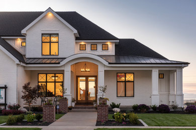 Large cottage white three-story brick house exterior idea in Salt Lake City with a hip roof and a shingle roof