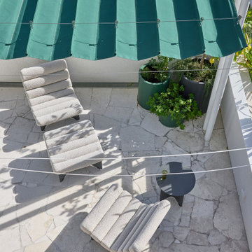 Relaxed Balcony with Awning and Lounge Chairs
