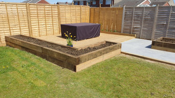 Tile patio, decking and raised sleeper beds.