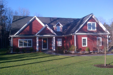 Inspiration for a mid-sized craftsman red two-story wood exterior home remodel in Boston with a shingle roof