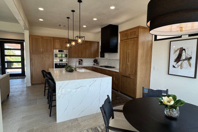 Eat-in kitchen - mid-sized transitional l-shaped porcelain tile and gray floor eat-in kitchen idea in Phoenix with an undermount sink, shaker cabinets, medium tone wood cabinets, quartz countertops, white backsplash, quartz backsplash, paneled appliances, an island and white countertops