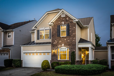 Example of a mid-sized brown three-story mixed siding house exterior design in Raleigh with a brown roof