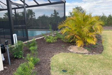 Design ideas for a large traditional backyard concrete paver landscaping in Other.