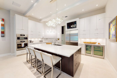 Photo of a modern l-shaped kitchen in Tampa with flat-panel cabinets, white cabinets and white benchtop.