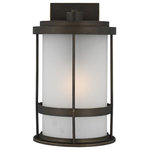 Sea Gull Lighting - Sea Gull Wilburn Medium 1 Light Outdoor Wall Lantern, Bronze/Satin - With a nod to retro-industrial chic, the Wilburn outdoor fixtures wraps a white frosted glass shade in a fun metal cage to create a casual and easygoing look. Offered in Antique Bronze and Black finishes with Etched White glass, the assortment includes a one-light outdoor pendant, small medium, large, and extra-large one-light outdoor wall lanterns, a one-light out door post lantern and a one-light outdoor ceiling flush mount. Both incandescent lamping and ENERGY STAR-qualified LED lamping are available for most of the fixtures, and some can easily convert to LED by purchasing LED replacement lamps sold separately.