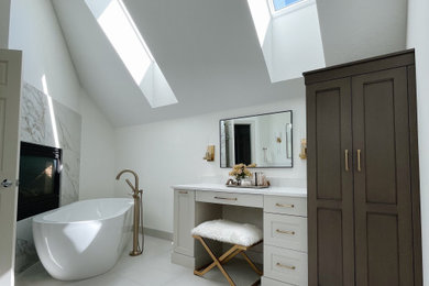 Bathroom - large transitional master gray floor, double-sink and vaulted ceiling bathroom idea in Minneapolis with shaker cabinets, gray cabinets, a one-piece toilet, white walls, an undermount sink, a hinged shower door, white countertops and a built-in vanity