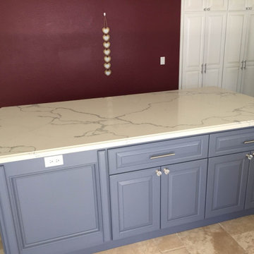 Kitchen blue cabinets island with Calacatta Gold Quartz countertops