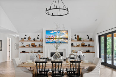 Inspiration for a large cottage u-shaped laminate floor and vaulted ceiling open concept kitchen remodel in Portland with a farmhouse sink, shaker cabinets, medium tone wood cabinets, quartzite countertops, white backsplash, ceramic backsplash, stainless steel appliances, an island and white countertops