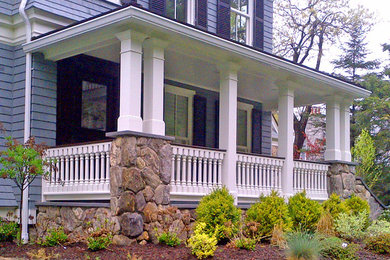 This is an example of a traditional front yard verandah in Boston with a roof extension.