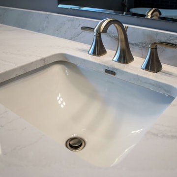 Primary Bathroom with Blue-Gray Vanity and Deep Blue Tiled Feature Wall
