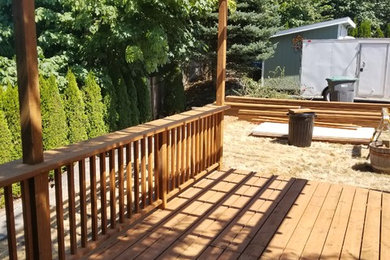 Deck - mid-sized traditional backyard deck idea in Seattle with a pergola