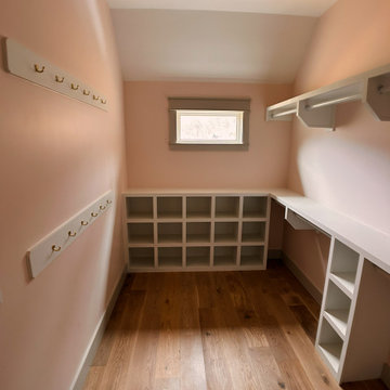 Elegant Guest Closet Organization: White Built-Ins, Open Cubbies, and Hanging St