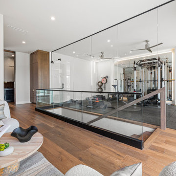 Modern Luxury Lakehouse Glass-Enclosed Home Gym with Adjacent Relaxation Nook