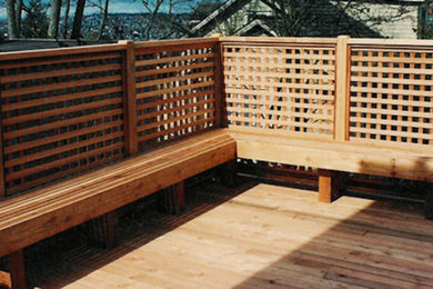 Example of a mid-sized backyard deck design in Seattle with no cover