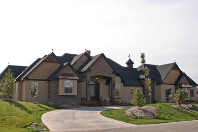 Large 1960s beige three-story stucco gable roof photo in Boise