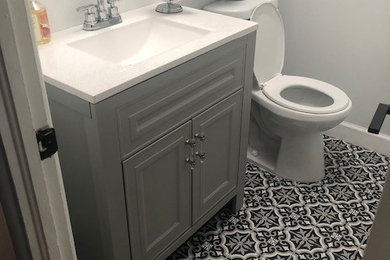 Small trendy kids' white tile and ceramic tile ceramic tile and black floor bathroom photo in Orlando with raised-panel cabinets, gray cabinets, a one-piece toilet, white walls, an integrated sink, quartz countertops and white countertops