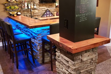 Inspiration for a mid-sized industrial walk-out dark wood floor basement remodel in Omaha with beige walls