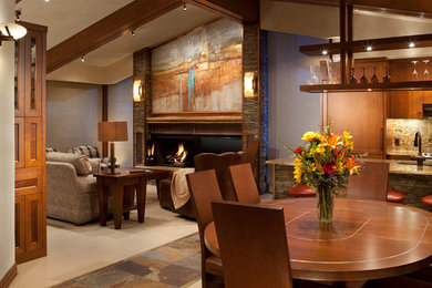 Inspiration for a mid-sized contemporary enclosed carpeted living room remodel in Denver with beige walls, a standard fireplace, a metal fireplace and a tv stand