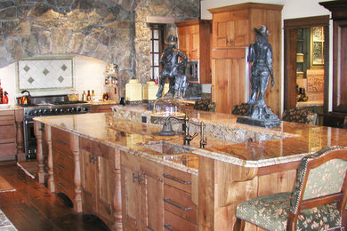 Example of a large mountain style l-shaped medium tone wood floor and brown floor eat-in kitchen design in Other with an undermount sink, shaker cabinets, medium tone wood cabinets, granite countertops, white backsplash, ceramic backsplash, stainless steel appliances and an island