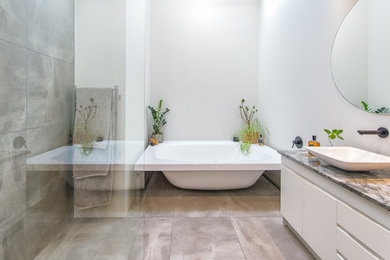 Mid-sized contemporary bathroom in Other with a freestanding tub, an open shower, white walls and an open shower.