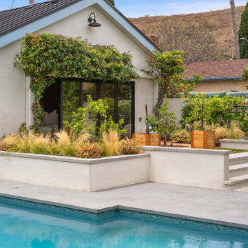 Home Exterior with Vine-Covered Patio & Raised Planters