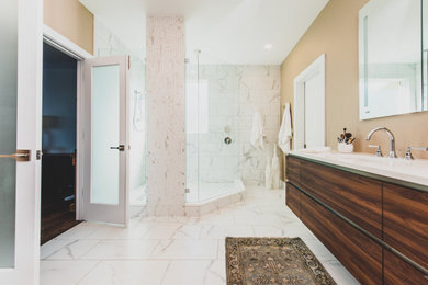 Example of a mid-sized trendy master porcelain tile, white floor and double-sink bathroom design in Tampa with flat-panel cabinets, brown cabinets, a one-piece toilet, beige walls, a drop-in sink, white countertops and a floating vanity