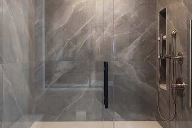 Sliding shower door - large transitional master gray tile and porcelain tile double-sink sliding shower door idea in Charlotte with recessed-panel cabinets, green cabinets, an undermount sink, quartz countertops, white countertops, a niche and a built-in vanity