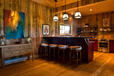 Inspiration for a mid-sized rustic galley medium tone wood floor open concept kitchen remodel in Toronto with recessed-panel cabinets, stainless steel appliances, a peninsula, dark wood cabinets, brown backsplash and wood backsplash