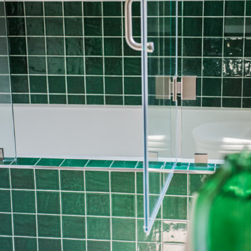 Vibrant Green Ceramic Tiles Bring Life to a Hallway Bathroom