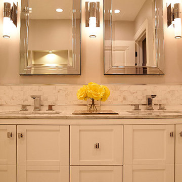 Elegant Double Vanity with Framed Mirrors and Modern Wall Sconces