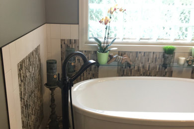 Bathroom - large eclectic master white tile and ceramic tile porcelain tile and brown floor bathroom idea in Minneapolis with recessed-panel cabinets, green cabinets, a bidet, green walls, an undermount sink, quartz countertops and a hinged shower door