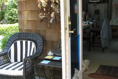 Inspiration for a small eclectic backyard patio remodel in New York with a roof extension