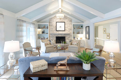 Inspiration for a transitional open concept light wood floor family room remodel in St Louis with a standard fireplace and a stone fireplace