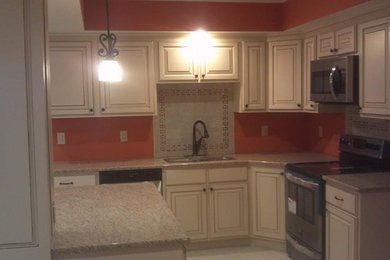 Mid-sized elegant l-shaped white floor open concept kitchen photo in Chicago with a double-bowl sink, raised-panel cabinets, white cabinets, granite countertops, stainless steel appliances and an island