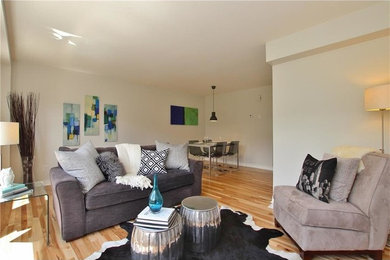 Inspiration for a mid-sized contemporary open concept light wood floor and beige floor living room remodel in Ottawa with white walls, no fireplace and no tv